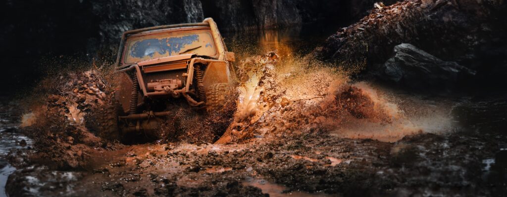 ATV Pushing through muddy and rocky water pool