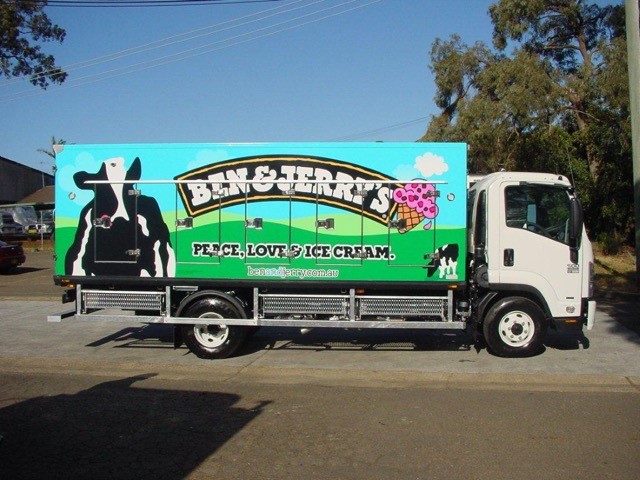 Ice cream truck featuring Ben & Jerry's branding, showcasing vibrant colors, cow graphics, and the slogan "Peace, Love & Ice Cream."